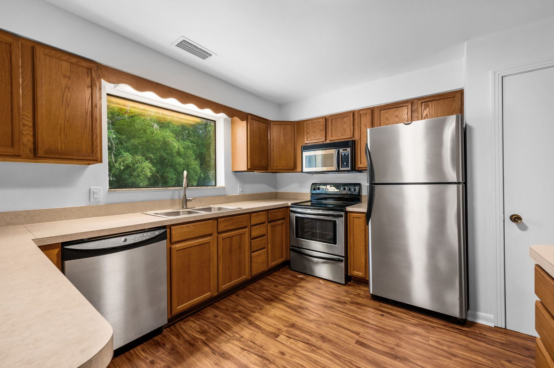 Kitchen with stainless appliances and garden window